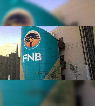 The image displays the FNB (First National Bank) logo prominently on a modern building, directly representing the South African bank mentioned in the post that has partnered with VALR to launch crypto trading services for BTC, ETH, XRP, SOL, and USDT.