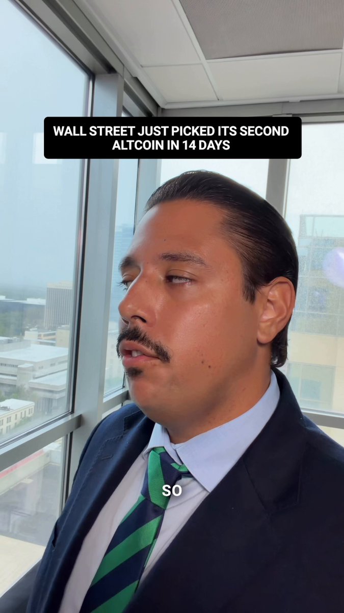 The image shows an older man dressed in a suit with a green tie, standing behind a window at an office building. A quote is written above him that reads "Wall Street just picked its second altcoin token, AltCoinIn14 days, to tokenize real US stocks, ETFs and Treasuries". The context of the photo suggests it might be related to some sort of business or financial development involving the use of altcoins for tokenizing stock trading.