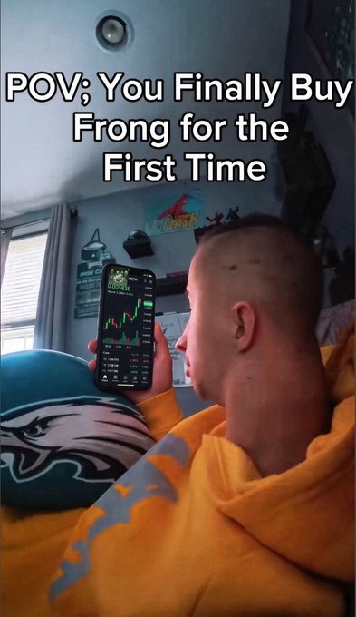 A meme image with text "POV; You Finally Buy Frong for the First Time" showing a young boy in a yellow Eagles hoodie looking at a stock chart on his phone.