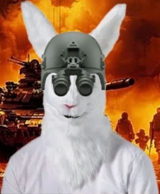 A white rabbit wearing a military helmet with night vision goggles stands in front of a fiery battlefield with tanks and soldiers. The meme pairs the "we start blasting at dawn" quote with the armored bunny to humorously portray readiness for chaotic, high-stakes combat.