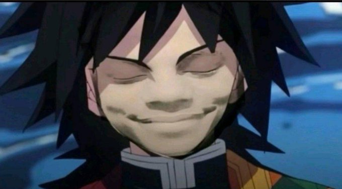 An anime character with spiky black hair smiles with closed eyes, showing a stitched or scarred mouth, wearing a colorful checkered garment.