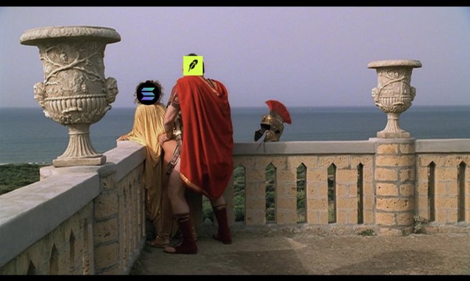 Two figures in Roman-style robes (one yellow, one red with armor) stand at a stone balustrade overlooking the sea, with an empty plinth and a small cactus visible; yellow edit marks appear over their faces.
