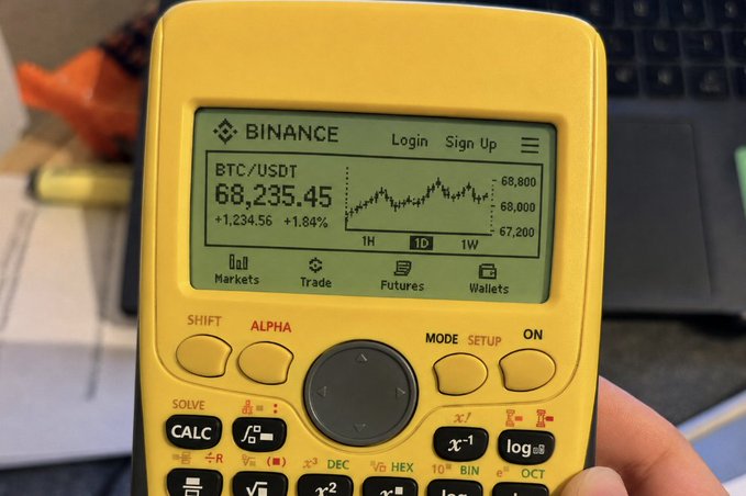 A graphing calculator displays a custom Binance interface showing BTC/USDT at $68,235.45 (+1.84%) with a 1D candlestick chart—a nostalgic nod to "old school" trading. The humorous image captures the meme spirit of OG crypto traders swapping modern smartphones for retro Texas Instruments-style devices.