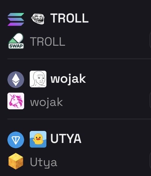 The image shows a phone screen displaying three different logos for cryptocurrency wallets, with each logo accompanied by its name. The first logo features a cartoon face of a troll, while the other two logos have a unicorn and a bird design. The names of these wallets are "UTYA", "WOJAK", and "TROLL". The phone screen also has a small icon of a yellow duck on it.