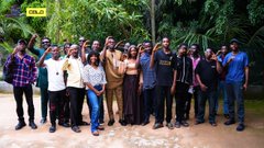 The image shows a large group of people standing together outdoors, possibly at an event or gathering. They are all smiling and posing for a photo, creating a sense of camaraderie among them. The background features trees, indicating that they might be in a park or a similar outdoor setting. The post includes text about the @Celo Build Day, which is likely related to the event where this group of people gathered.