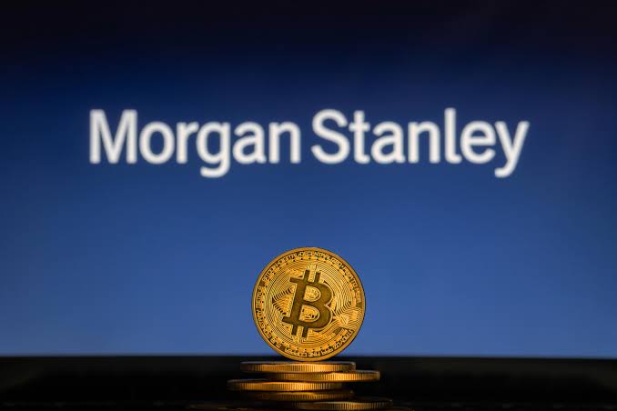 A gold Bitcoin coin stands in front of a screen displaying "Morgan Stanley" against a blue background. The image visually reinforces the post's message about Morgan Stanley, a $9.3 trillion firm, filing amended S-1s with the SEC for Ethereum and Solana ETFs, signaling a major move into the crypto space.
