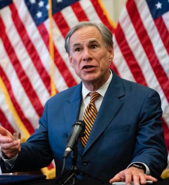 The image features a man wearing a suit, speaking into a microphone at a podium with an American flag behind him. The text "BREAKING: TEXAS JUST ANNOUNCED THEY ARE PLANNING TO BUY MORE #BITCOIN FOR THEIR RESERVES 1st STATE TO BUY BTC OPENLY." This suggests that the man is addressing a significant event or announcement related to Bitcoin, possibly in Texas.