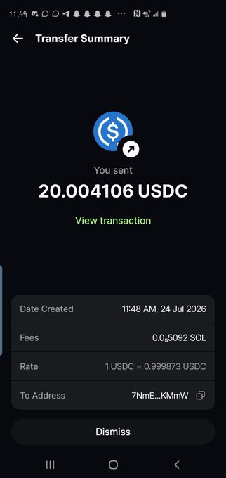 A mobile screenshot of a "Transfer Summary" screen showing a completed transfer of 20.004106 USDC sent to an address ending in "KMmW," with a transaction fee of 0.0₅092 SOL and a rate of 1 USDC ≈ 0.999873 USDC, dated 11:48 AM on 24 Jul 2026—visually confirming the $20 USDC gift mentioned in the post.