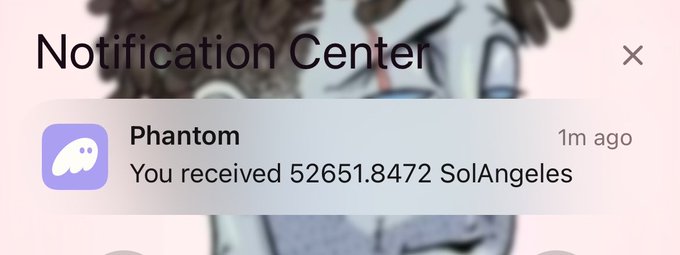 A Notification Center pop-up from the app 'Phantom' stating 'You received 52651.8472 SolAngeles'.