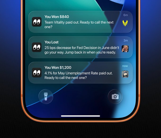 A smartphone displays Polymarket notifications showing auto-redeemed positions, including a $840 win on Team Vitality, a loss on a Fed Decision bet, and a $1,200 win on May Unemployment Rate—demonstrating the app's automatic redemption feature in action.