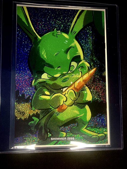 A holographic 'SHIMMER' trading card (#299) depicting a green rabbit-like character holding a carrot against a glittery background.