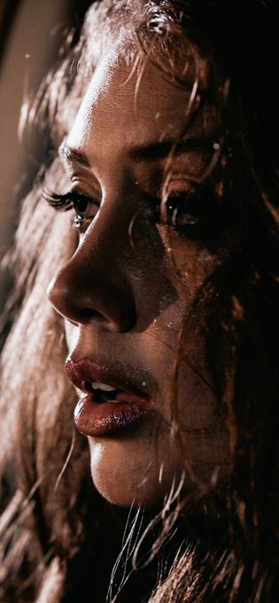 The image features a woman with long brown hair, looking down at her face as she looks into the distance. She has dark eyes that are open wide, giving off an intense gaze. The background of the photo appears to be a light grey color, which contrasts nicely with the woman's hair and makes it stand out more. There is also text in the image that reads "GN Good projects don't just solve problems they create possibilities..." This quote adds a layer of depth to the scene and could potentially be related to the content of the post on social media or other platforms.