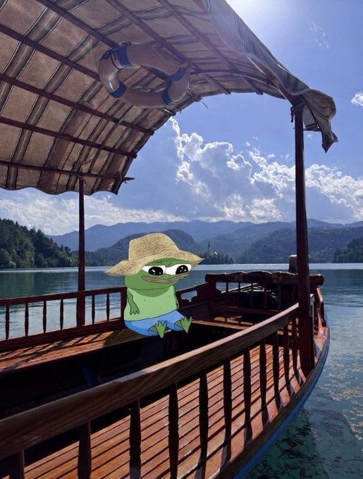 A cartoon green frog character wearing a straw hat, sitting on a wooden boat with a canopy on a calm lake surrounded by mountains, with a life preserver visible on the roof.
