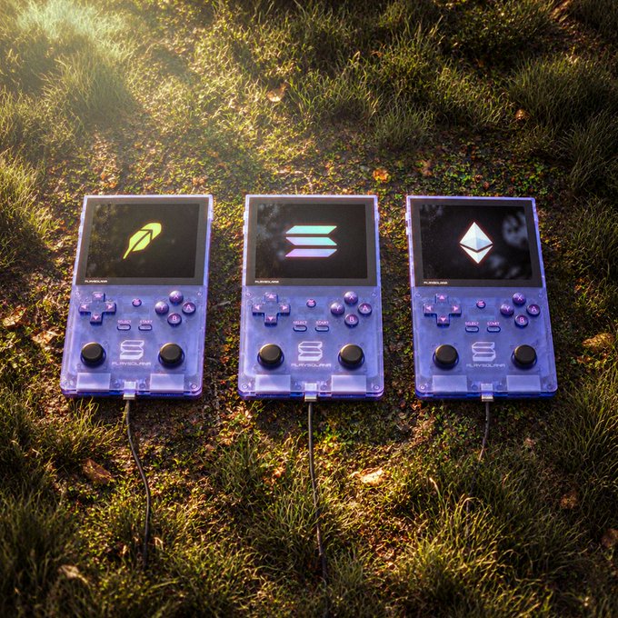Three transparent purple handheld gaming devices sit on grass displaying Solana ecosystem logos (SOL, a rainbow "S," and Ethereum's diamond), illustrating how the blockchain community stands "Stronger Together" across networks.