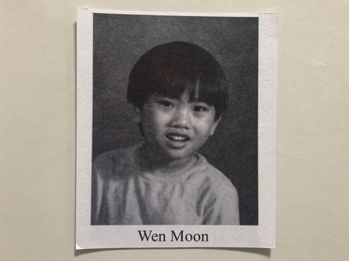 A black-and-white Polaroid-style portrait of a smiling young child with short dark hair, labeled 'Wen Moon' beneath the photo.