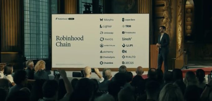 A man on stage presents a slide titled "Robinhood Chain" featuring logos of various blockchain partners including Morpho, LayerZero, Lighter, TRM, Uniswap, Chainstack, PAXOS, 1inch, Arbitrum, LLFi, alchemy, 0x, Chainlink, RIALTO, and JISCIS, while an audience watches and takes photos in an ornate venue. The image relates to "Good company" by highlighting Robinhood's collaboration with these notable crypto and blockchain firms as part of its new chain initiative.