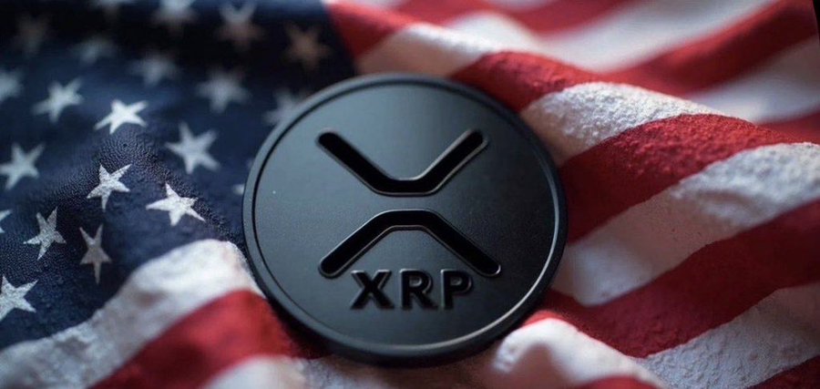 The image features a circular emblem engraved with the XRP logo. Displayed on a backdrop of the American flag.