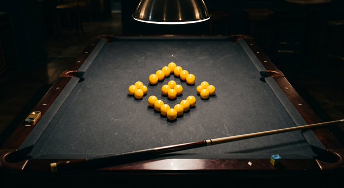 A dimly lit pool table is illuminated by a hanging overhead lamp, with yellow pool balls artfully arranged in a diamond pattern on the green felt and a cue stick resting nearby.