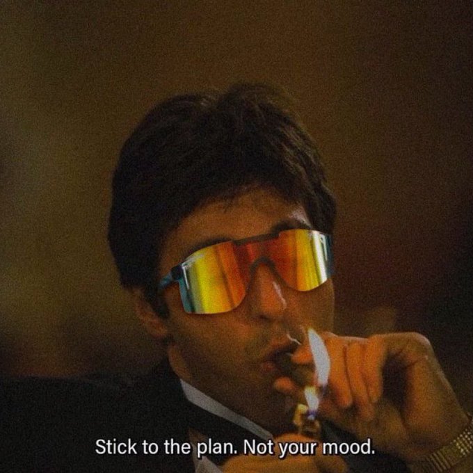A retro-style photo shows a man wearing rainbow-colored reflective sunglasses smoking a cigar, with the caption 'Stick to the plan. Not your mood.'