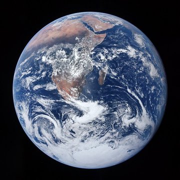 A view of Earth from space, showing the planet suspended against the black backdrop of the cosmos—a striking reminder of how small and unified the world is. In the context of the fun fact, it symbolizes how Bitcoin ownership, like the global community itself, is concentrated in the hands of very few, with just a fraction of a single coin placing you among the rarified top 1% worldwide.
