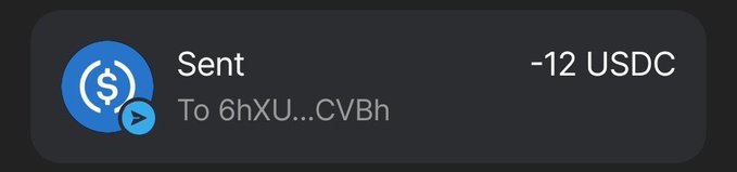 A cryptocurrency transaction notification showing "Sent" "-12 USDC" "To 6hXU...CVBh" with the USDC logo.