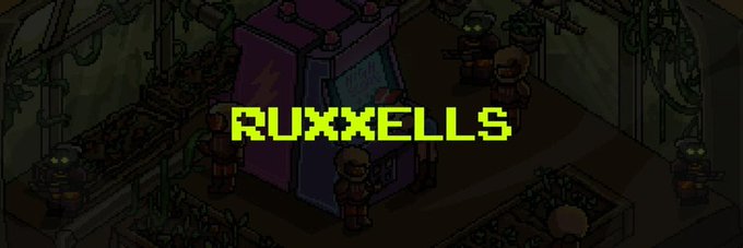 A pixelated game scene shows the text 'RUXXELLS' in bright yellow-green letters over a dimly lit industrial area with small characters.