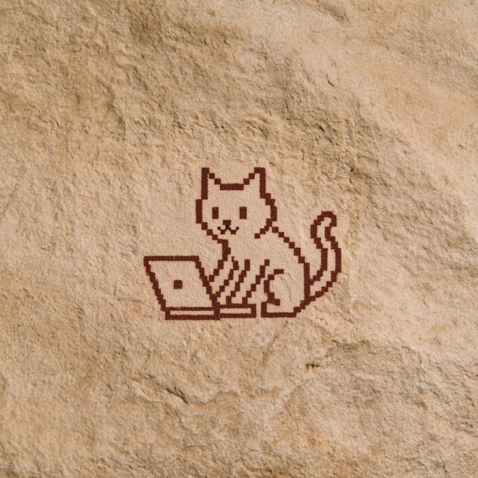 A pixel-art cat sits at a laptop on a textured, stone-like surface. The accompanying caption calls it an “Ethereum relic,” suggesting the cat-and-computer graphic is meant to evoke Ethereum’s early culture or history.