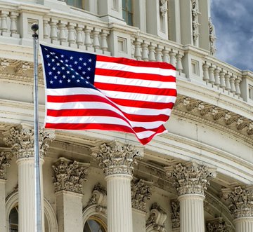 The image features a large American flag flying high above a building, possibly the United States Capitol. The flag has white stars on a blue background, which are the iconic symbols of the country's national identity. In the surrounding area, there are columns that add architectural interest and prominence to the scene. The text in the image reads "LATEST- @Bitwise CIO Matt Hougan says the Clarity Act doesn't matter to crypto anymore ready for 1000X #Xrp #Altcoin season". This message seems to be related to a recent development or trend in the cryptocurrency world, possibly involving the clarity act and its impact on the crypto industry.