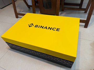 The image features a yellow box with "Binance" written on it, placed on a tiled floor. The box has a black border around its edges, giving it an elegant appearance. It appears that someone has left the box open, as there is no visible lid or cover on it. The background of the image shows a dining table and chairs, suggesting that this scene might be taking place in a room where people gather for meals or socializing.

The post about Bitcoin seems to be promoting an event related to cryptocurrency or digital currency. It could be an advertisement for a Bitcoin conference, a product launch, or even a discussion on the future of money and technology. The image's content is likely intended to catch the attention of potential attendees or customers interested in learning more about Bitcoin and its implications.
