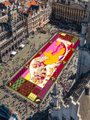 An aerial view shows a vibrant yellow rubber-duck–shaped parade float being pulled through a city street lined with spectators. The image playfully illustrates the post's joke that SWIFT can't publicly acknowledge XRP, while everyone already knows it.
