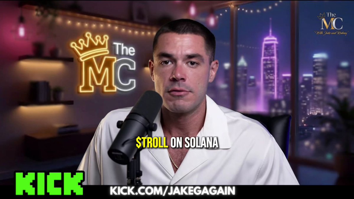 A man wearing a white shirt sits at a microphone in front of a background featuring various buildings, including one labeled "The MC" which could be part of a radio show or podcast. The caption indicates that this person's name is TROLL and he has made a significant amount of money for the show, reaching $95M MC today compared to his former $69M MC value. A large blue crown is displayed above him in the background as well.