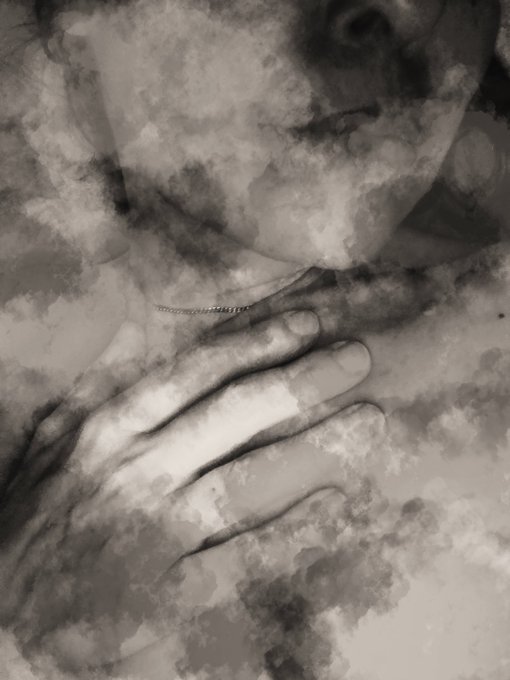 A moody, grayscale artistic image shows a hand covering a face, obscured by cloudy, ink-like textures.