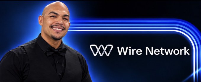 A smiling bald man in a black shirt and bow tie stands in front of a blue background displaying the 'Wire Network' logo.