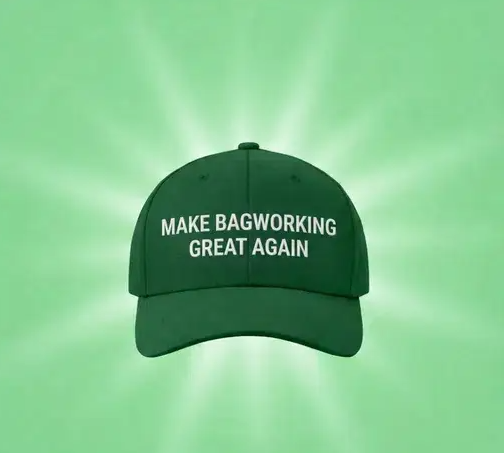 A green baseball cap with the white text 'MAKE BAGWORKING GREAT AGAIN' is displayed against a matching green background with radiating light beams.