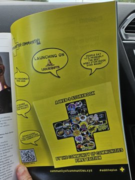 A hand holds open a magazine page featuring a yellow advertisement for "community.xyz" announcing the launch of a book on "SocialFi," available on AbeBooks and other bookstores. The ad promotes the book as a guide to understanding communities in the digital age, tying into the post's recommendation of crypto and NFT-related reading material.