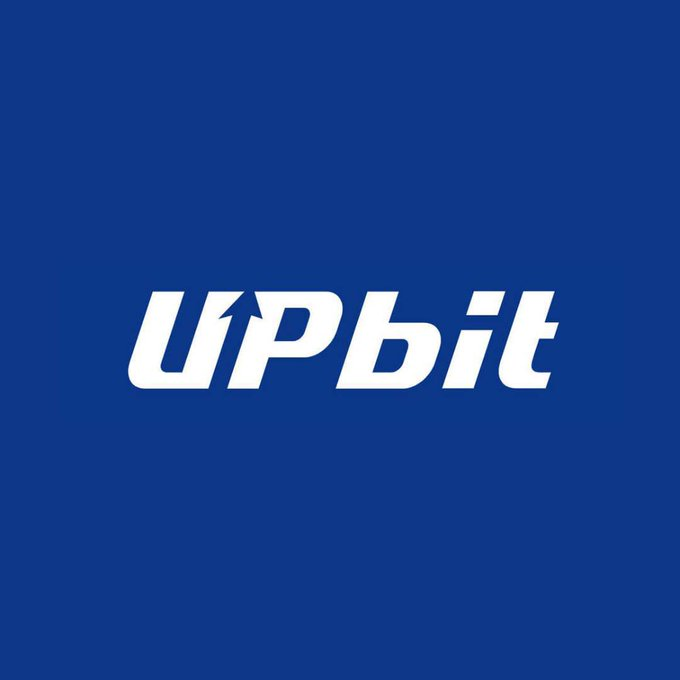 The image displays the white "UPBit" logo (stylized with an upward arrow integrated into the "U") centered on a solid dark blue background. This branding directly corresponds to the news of Upbit's parent company Dunamu partnering with Visa to develop next-generation stablecoin and AI-powered financial services.
