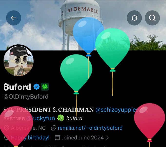 A Twitter/X profile for "Buford" (@OldDirtyBuford), featuring a green frog avatar, location listed as Albemarle, NC, with colorful balloon emojis overlaid on the image of a water tower.