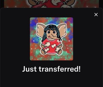 A dark digital notification window shows a cartoon gremlin-like character in a red outfit above the text 'Just transferred!'.