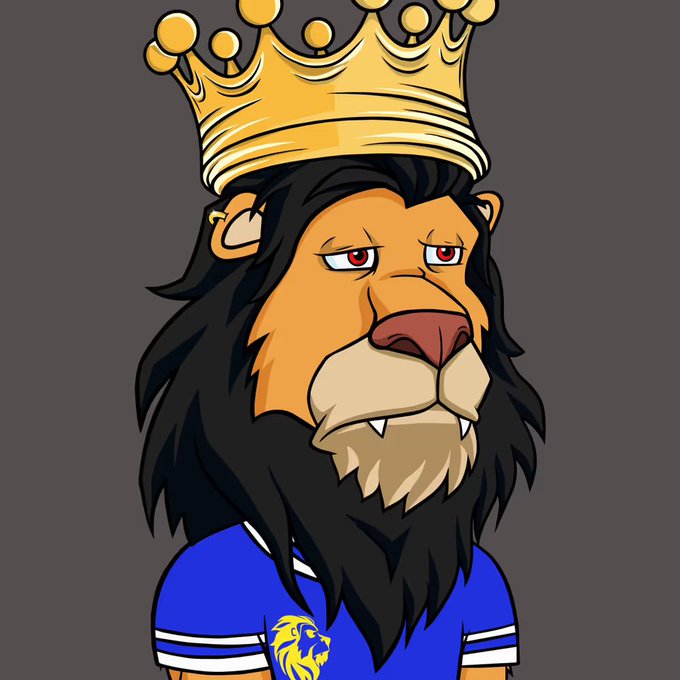 A cartoon illustration of a lion character with a black mane wearing a golden crown and a blue t-shirt featuring a lion logo.