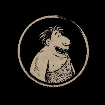 A vintage-style illustration of a smiling, scruffy caveboy with a large nose inside a circular border on a black background.