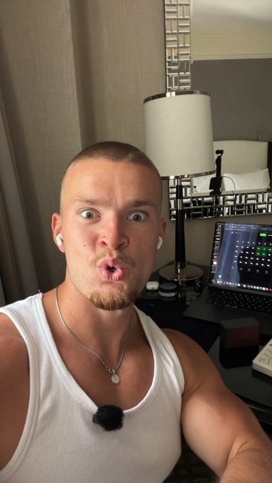 A surprised man in a white tank top takes a selfie in a room with a laptop, lamp, and mirror, wearing earbuds and a microphone. The post promotes a live viewer hunt with cash prizes for @degencom ($3,500), @raindotgg ($2,500), and @clashdotgg ($1,500) on kick.com/jackedgambles.