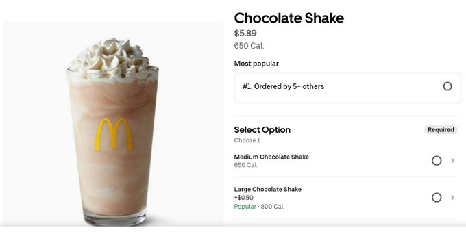 A McDonald's menu listing shows a Medium Chocolate Shake priced at $5.89 (650 Cal.) and a Large Chocolate Shake at $6.39 (800 Cal.), highlighting the high cost of the beverage and supporting the post's complaint that you can't even get a $5 shake anymore, which the poster attributes to inflation or currency devaluation by tagging #Bitcoin.