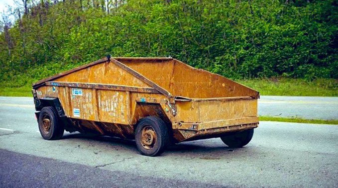 A rusty, weathered orange industrial dumpster trailer parked on an asphalt surface with a green leafy background.
