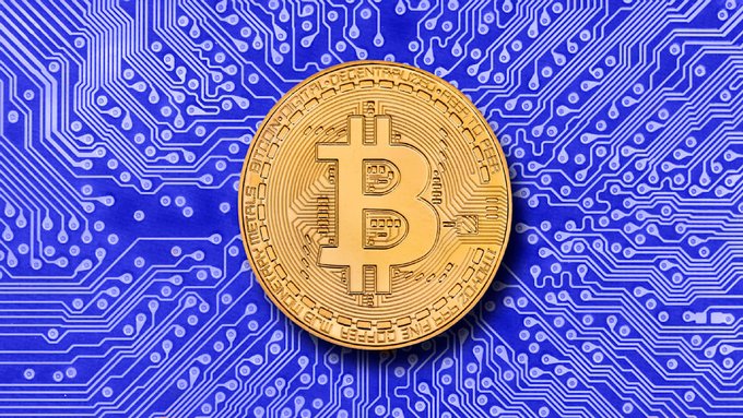 A golden Bitcoin coin rests on a vibrant blue circuit board, symbolizing digital currency. The image reinforces the post's message about Bitcoin's growing prominence and parallels drawn with traditional stores of value like gold.