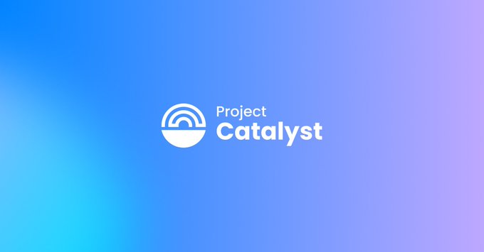 A blue gradient background displays the white "Project Catalysts" logo alongside a circular emblem with a radiating wave design. The branding aligns with the post's discussion of the Catalyst program, which proposes paying Cardano full-time employees reduced wages tied to commercial milestones.