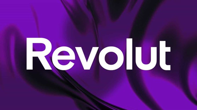 The image features the "Revolut" logo in bold white text against a vibrant purple background with flowing, abstract black ribbon-like patterns. This visual directly ties to the post's announcement about Revolut's rollout of its euro-pegged EURR stablecoin to customers in select European countries, symbolizing the fintech brand's push to bring stablecoins into mainstream European finance.