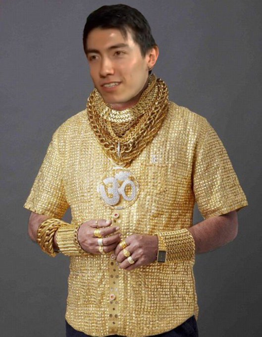 A man models an extravagant outfit entirely covered in gold, featuring a gold sequined shirt, multiple thick gold chains, a gold pendant with the number "30," a gold watch, and numerous gold rings on his fingers, playing on the "GM have a blast today" post by visually embodying wealth and opulence.