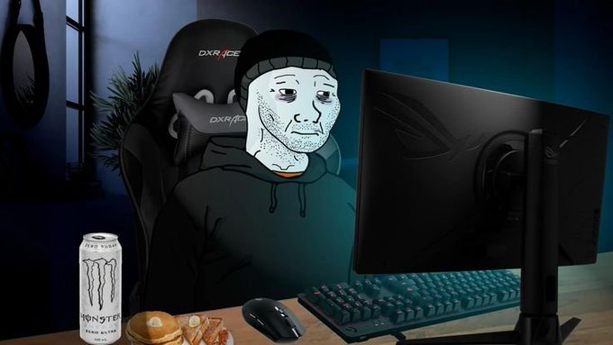A Wojak meme character sits in a DXRacer chair at a gaming setup featuring a curved monitor, mechanical keyboard, mouse, a Monster energy drink, and a burger with fries on the desk.