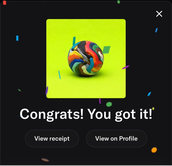 A "Congrats! You got it!" notification screen showing a multicolored patterned sphere on a green background, with buttons to "View receipt" or "View on Profile."