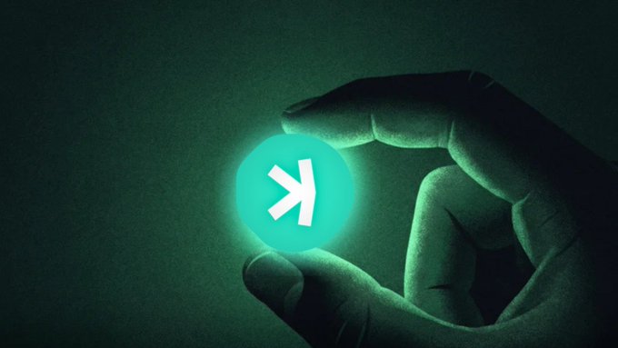 A hand holds a glowing green coin engraved with the Kaspa "K" symbol against a dark background. The image visually represents the $KAS token being suppressed and ignored, mirroring the post's claim that it poses a threat to the broader crypto and payments industry while being sidelined by major players.

Text visible: **$KAS** (with the Kaspa "K" logo).